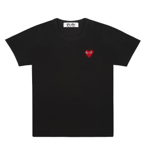 Svart t-shirt Comme des Garçons Play - Svart t-shirt från Comme des Garçons Play med det ikoniska röda hjärtat med ögon broderat på bröstet. Klassisk rund hals och korta ärmar. Tillverkad i mjuk bomull som känns skön mot huden. Perfekt för dig som gillar stilrena plagg med en twist.