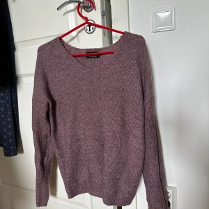 Lila stickad tröja från ONLY - Mysig lila stickad tröja från ONLY med v-ringning och lång ärm.