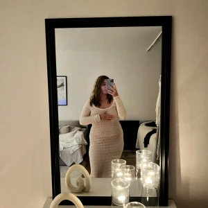 Beige stickad långklänning - Säljer en mysig beige stickad långklänning med v-ringad design. Klänningen har långa ärmar och en figurnära passform som framhäver silhuetten. Perfekt som ”strand klänning” 🫶🏼Endast testad!