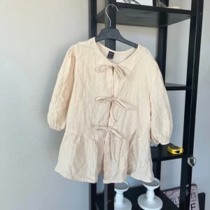 Fin topp - En fin topp med snören på framsidan som knyts. 