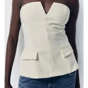 Vit axelbandslös korsettopp - Supersnygg vit axelbandslös korsettopp från Zara, aldrig använd och köpt för 359kr!❤️❤️skriv för egna bilder. 