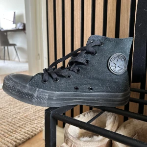 Svarta Converse All Star sneakers - Säljer ett par klassiska svarta Converse All Star sneakers i hög modell.  Perfekta för en avslappnad stil.