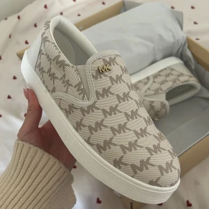 Michael Kors slip on skor  - Helt nya i kartong. Går ej att köpa längre, nypris va ca 2000! Säljer då de tyvärr va för stora. Storlek 36.