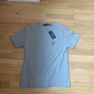 Polo Ralph Lauren t-shirt - Snygg grå t-shirt från Polo Ralph Lauren med klassisk passform och korta ärmar. Tillverkad i mjuk bomull.