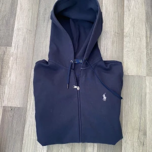 Ralph lauren ziphoodie mörkblå - Säljer nu denna feta mörkblåa ziphoodien från Ralph lauren! Skicket är 9/10 Inga fel eller defekter! Pris kan diskuteras vid rimligt pris. Tveka inte att höra av dig vid minsta fundering!;)