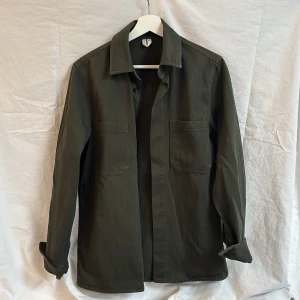 Mörkgrön overshirt från Arket, stlk 44 - Säljer en stilren mörkgrön overshirt från Arket. Sparsamt använd. 
