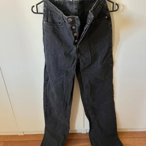 Svarta jeans med knappar - svarta jeans med hög midja och knappar framtill. Från BikBok ”regular wide” waist 26 length 32
