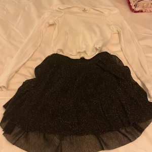 Fint fest sett från hm - Säljer en stilren vit långärmad topp från H&M. Toppen har en ribbad struktur och en elegant passform som passar perfekt till både kjol och byxor. Perfekt för en chic och enkel look.