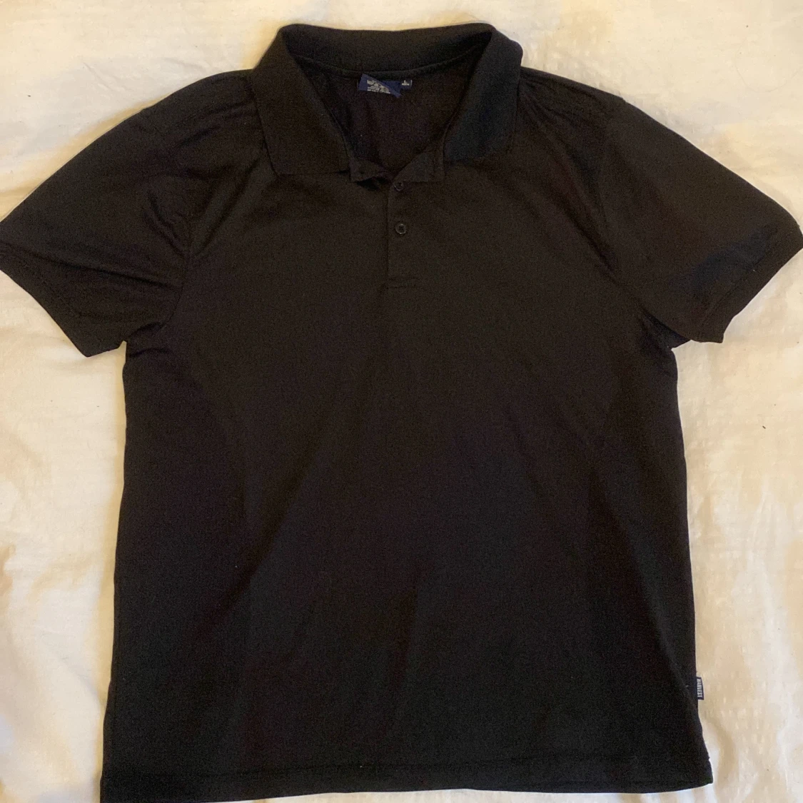 Svart pikétröja från James Harvest