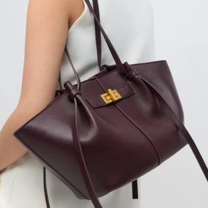 Gina tricot Vinröd handväska med gulddetaljer - Säljer denna helt slutsålda handväskan i burgundy från gina tricot🥰 Så snygg och inte använd! Lilla modellen