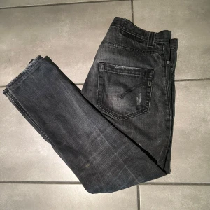Dondup Jeans - Säljer nu dessa svinsnygga Dondup jeans i svart färg. De har några slitningar men det var så när jag köpte dem på CareOfCarl för 3000kr. använda några gånger men är ändå i fint skick. Modellen på bilden är en och 83 cm och väger 73 kg. Hör av dig vid minsta fundering.🤝