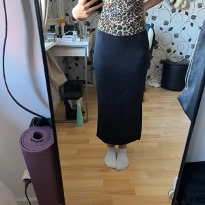 Svart ribbad långkjol  - Säljer en svart ribbad långkjol från lager 157 i storlek XS. Kjolen har en slim passform och en snygg slits på sidan som ger lite edge. 