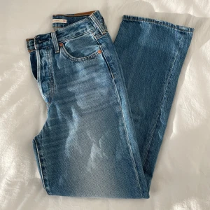 Levi's Ribcage Straight jeans blå stl 26 - Snygga Levi's Ribcage Straight jeans i klassisk ljusblå tvätt. Hög midja och raka ben. Köpta förra sommaren. Storlek 26x30. Supersköna o mjuka, sitter bra över rumpan