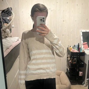 Beige och vit randig tröja från Cubus  - Beige tröja med vita horisontella ränder från Cubus i storlek XS. Långärmad med rund halsringning. 