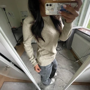 Beige stickad tröja från Vila - Säljer en enkel och snygg beige stickad tröja från Vila. Tröjan har rund halsringning, ribbade muddar och lång ärm. Perfekt att slänga på sig när det är lite kyligare ute. Passar dig som gillar en clean och stilren look. Kan alltid diskutera pris. Skriv för frågor och bilder🥰🥰