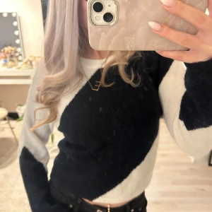 Svart och vit stickad tröja från Gina Tricot - Säljer en stickad tröja från Gina Tricot i svart och vitt med coolt, snedrandigt mönster. Tröjan har rund halsringning och långa ärmar. Perfekt för dig som gillar en enkel men snygg stil.