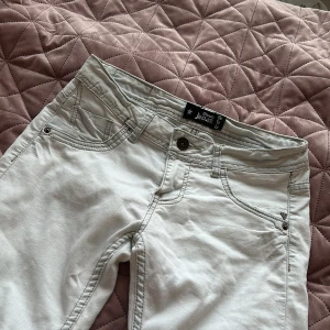 Vita lågmidjade jeans från Blanco jeans - Säljer ett par vita jeans från Blanco jeans. Benen ska vara flared men är ganska raka, förra ägaren har klippt längst ner på benen! Annars är de i ett bra skick.🤍