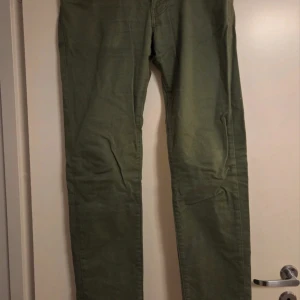 Olivgröna byxor från Dobber - Snygga olivgröna byxor från Dobber med raka ben och klassisk femficksdesign. Byxorna är tillverkade i bomull och har en normal passform. Perfekta för dig som gillar en enkel och stilren look.