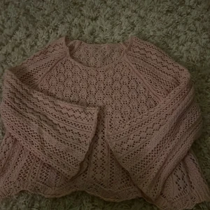 Rosa stickad tröja - Säljer en söt rosa stickad tröja med ett detaljerat mönster. Tröjan har långa ärmar och en luftig design som passar perfekt för lager-på-lager. 💖