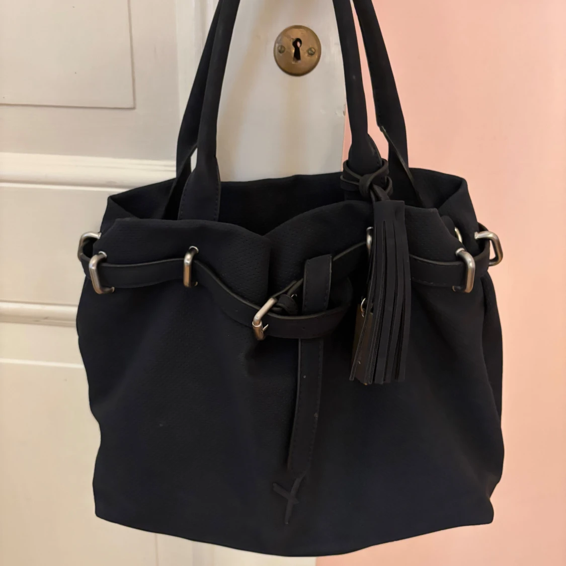 Svart axelväska med tofsdetalj