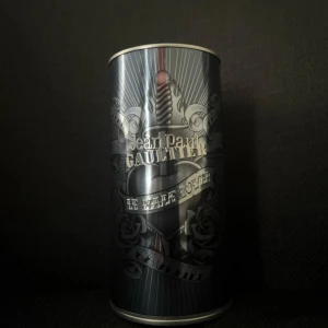 Jean Paul Gaultier Le Male Lover 125ml - Jean Paul Gaultier Le Male Lover Eau de Parfum 125ml. Flaskan har en mörkgrå, nästan svart kropp i form av en manlig torso med metallisk spraydel. Kommer i en snygg metallburk med tatueringsinspirerad design och silverdetaljer. Perfekt för dig som gillar unika och coola flaskor. Ungefär 110ml kvar.
