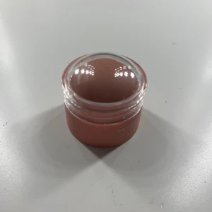 Rosa krämrouge i burk - Säljer en rosa krämrouge från NILL PONN i en rund burk med kupolformat lock. Färgen är mjukt rosa och formulan är krämig, perfekt för att ge kinderna en naturlig glow. Enkel att applicera direkt med fingrarna eller borste.