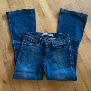 Blå bootcut jeans från Wrangler - Äkta blåa bootcut jeans från wrangler. Midjan är 27 cm och längden är 30 cm