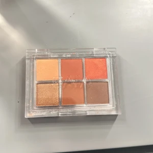 Heat Wave Eyeshadow Palette från Caia - Snygg ögonskuggspalett från Caia med sex olika nyanser: Tan, Flames, Spicy, Lava, Hotter och Desert. Perfekt för att skapa både vardagliga och dramatiska looks. Kompakt och lätt att ta med sig. Denna har jag aldrig använt så den är helt ny. Nypriset är 365kr.
