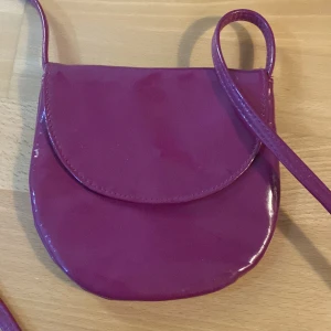 Rosa plats  - Rosa plats väska. Med lång handtag 