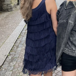 Marinblå fransklänning  - Marinblå klänning med fransar.