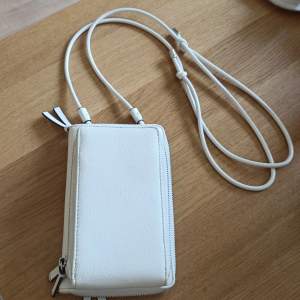 Faux leather phone wallet crossbag with silver hardware.