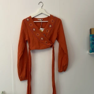 Orange top  - Så himla fin sommar top med knyt band ! Helt oanvänd. Asfint till en lång kjol elle liknande  