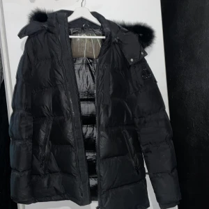 Oanvänd Moose knuckles jacka! - Helt oanvänd jacka i bra skick, köpte den i fel storlek (storlek M) och råkade tappa bort kvittot. Därav väljer jag att istället sälja den. En svart dunjacka med svart päls vid luvan. Köpte den för 16000kr. Pris kan diskuteras. 