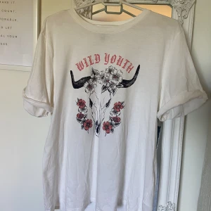 Oversized t-shirt med tryck - En vit oversized t-shirt med tryck i storlek S/M. Helt oanvänd, nytt skick. 