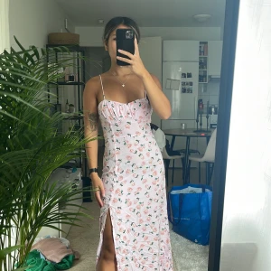 Blommig klänning  - En blommig rosa klänning som ha använts en gång! Klänningen har öppen rygg med snörning