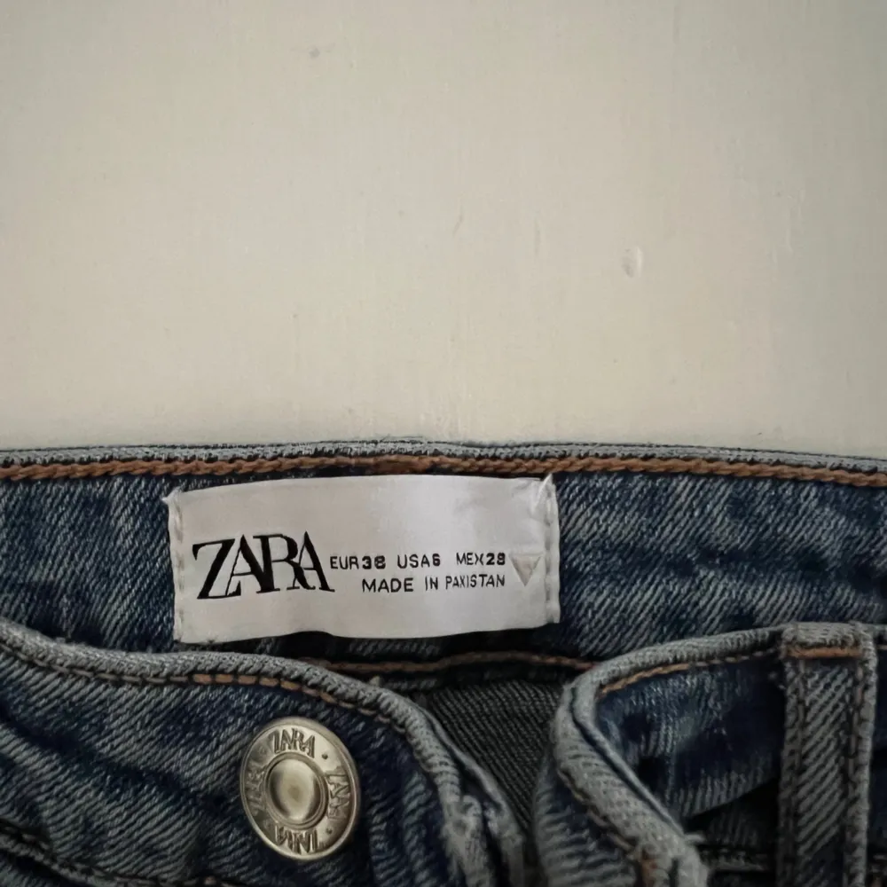 Säljer ett par blåa högmidjade jeans från Zara, med slitage vid knäna och slits på utsidan vid ankeln. Säljs pga att de aldrig använts, så är så gott som nya. Jag som är 176 tycker att de passar bra, på mig slutar de precis vid hälen (srl 38). Jeans & Byxor.