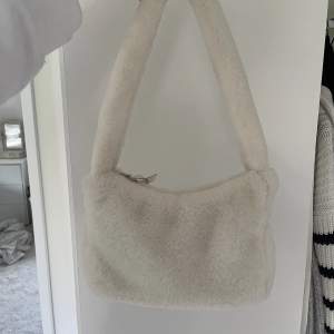 En supergullig fluffig vit väska i fakepäls, älskar den men tyvärr har den bara kommit till användning ett par gånger :( 