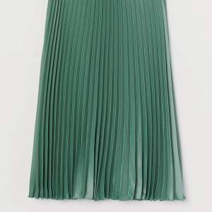 Grön plisserad kjol i sidenmaterial