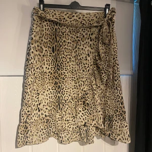 Kjol - Leopardmönstrad omlottkjol med knytning i midjan. Endast använd en gång, därav nyskick. 