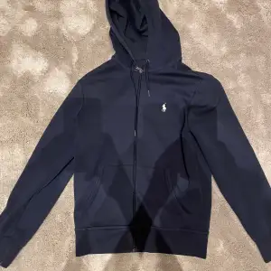 Snygg Ralph lauren zip hoodie köpt på nk i Göteborg. Hoodien är i storlek Xs. Den är använd sparsamt men inga defekter, därav skick 8/10. 