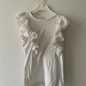 Blus/topp vit volang  - Sötaste vita toppen❤️❣️❤️‍🔥‼️💘🤍🤍perfekt till tex middag, fest eller sommar! Står ingen storlek men uppskattar xs! 