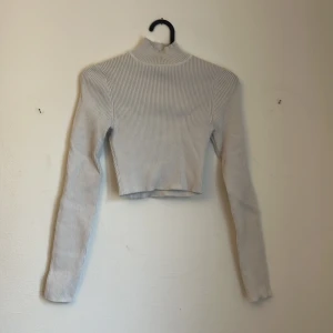 White turtleneck  - The color is off white and the pictures colour is a bit different due to lighting 
