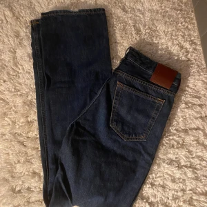 Lågmidjade jeans - Lågmidjade jeans i en mörkblå tvätt! I bra skick men lite slitna vid hälen! I storlek 25/32