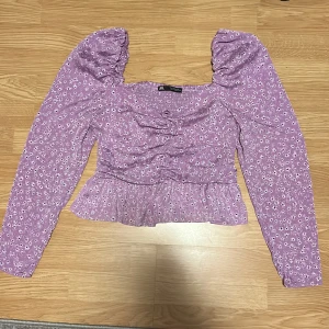 Blus/topp  - Syrenlila blommig sommar topp/blus från zara. Storlek S. Fint skick. Puffärmar och volanger och en rosett💗