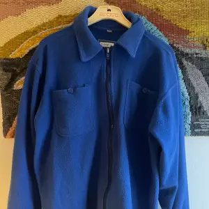 En overshirt med speciell material, och en snygg blå färg, väldigt skön och absolut ett unikt plagg! Passformen är minst lika bra! (Rakbotten)