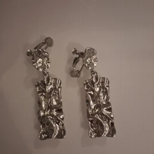 Silvriga örhängen 😊 - Silvriga öronhängen som aldrig är använa.  Säljer för 40 kr
