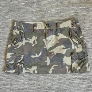 Minikjol - Minikjol med cammouflage. Midjemått 39cm, längd 32 cm. Köp via köp nu ❤️‍🔥