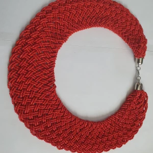 Handgjorda pärlhalsband - Tre handgjorda halsband med små pärlor i olika färger. Ett halsband är rött, ett är brunt och ett är lila med blå inslag. Halsbanden har en metallspänne för att enkelt kunna tas på och av.