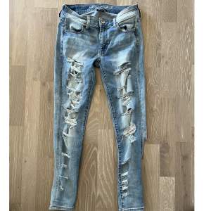 Super stretcht jeans från American Eagle outfitters, ripped jeans framsida och rippade vid vaderna  Storlek 6 US short 