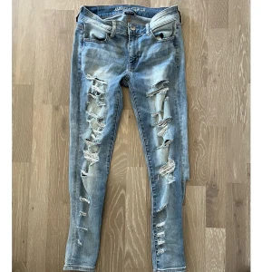 Super stretch ripped jeans American Eagle - Super stretcht jeans från American Eagle outfitters, ripped jeans framsida och rippade vid vaderna  Storlek 6 US short 